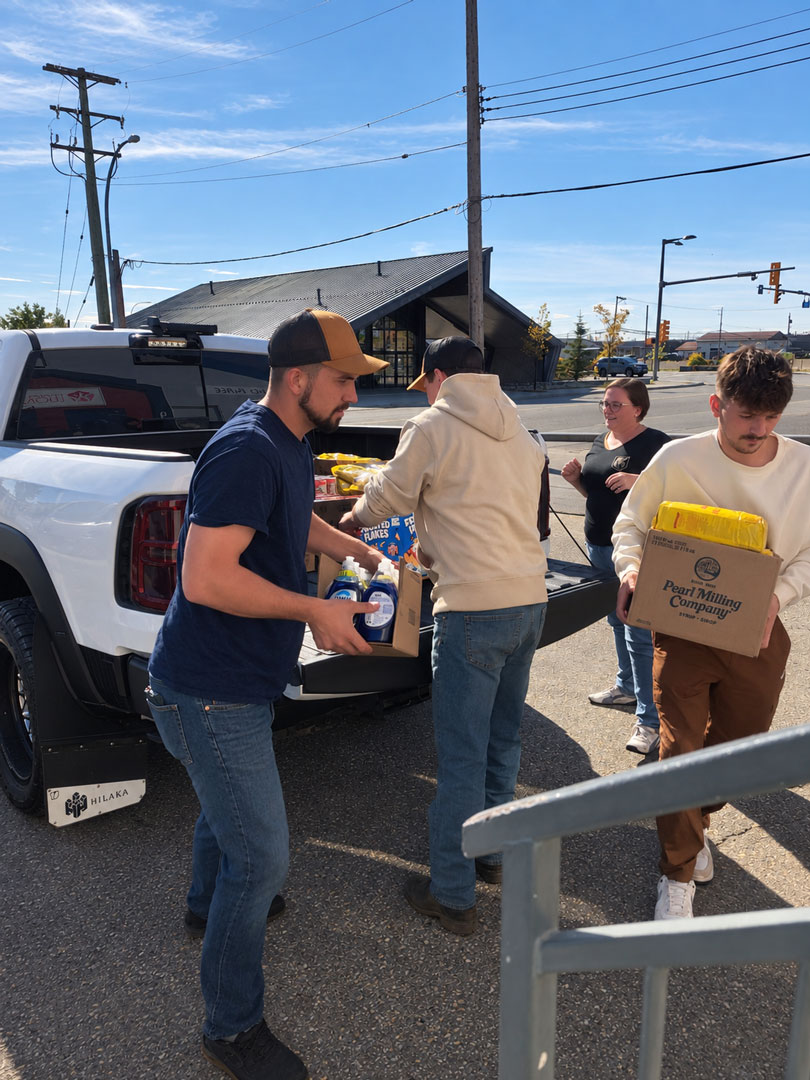 Hilaka employees unloading donated food to the Fort St. John Women’s Society